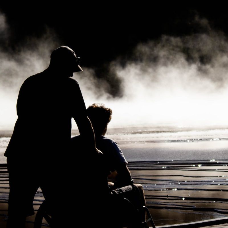 man and woman kissing on beach during daytime