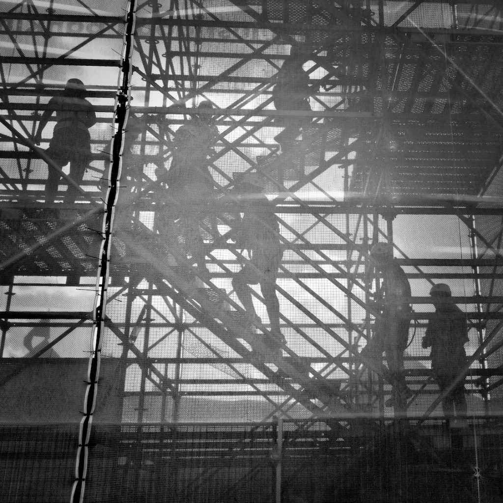 black and white photo of people going upstairs